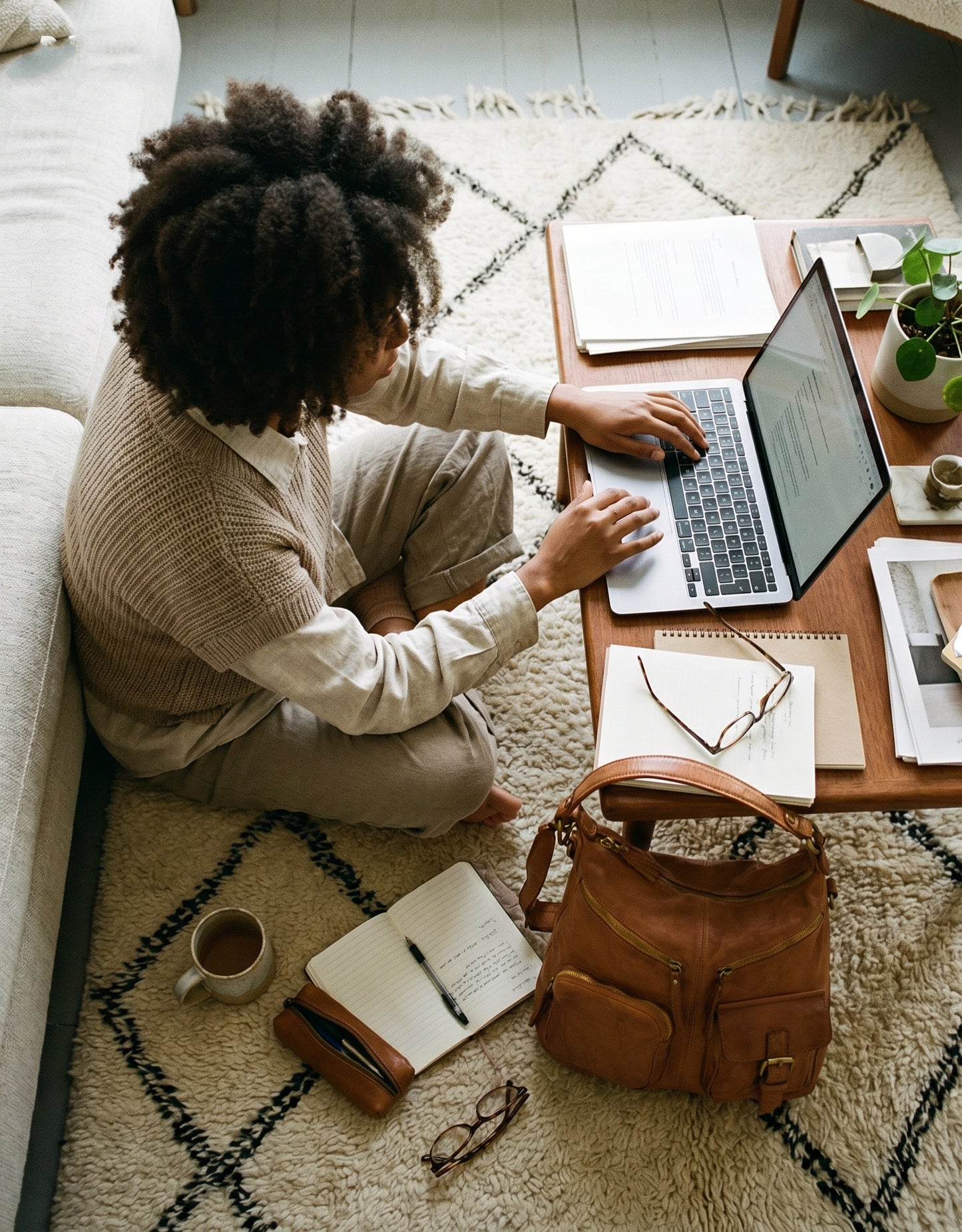 Moderne Business-Frau mit Leder Shopper beim Meeting im Café – stilvolle Unterbringung von Tablet, Dokumenten und Arbeitsutensilien