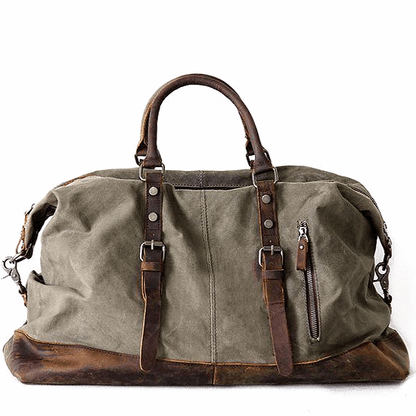  Vintage Damen Duffle Bag aus gewachster Baumwolle in Armeegrün mit doppelten Leder-Handgriffen und sichtbaren kleinen Metallfüßen am verstärkten Taschenboden.