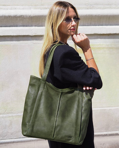 Woman with green Italian leather hobo bag shopping