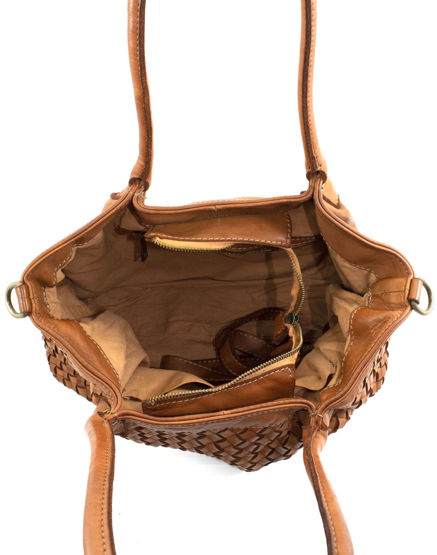 Detailaufnahme vom Innenraum der cognacbraunen Flechtleder Handtasche mit hellem Baumwollfutter Reißverschlussfach und praktischer 2-in-1 Fächeraufteilung