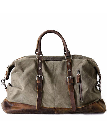 Große Damen Duffle Bag aus gewachstem 20 oz Canvas in Armygrün mit braunen Echtleder-Tragegriffen und geschlossenem Metall-Reißverschluss vor weißem Hintergrund.